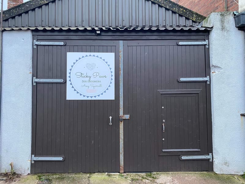 The Sticky Paws salon frontage on New Quay Street, with its dark wooden doors under a black canopy